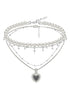 Sweet woven contrasting heart-shaped necklace with pearls layered on collarbone chain