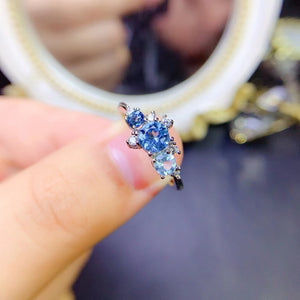 Genuine blue topaz round cut diamond ring